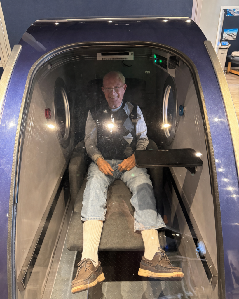Guest relaxing inside a hard-shell hyperbaric wellness chamber at The Peak in Scottsdale