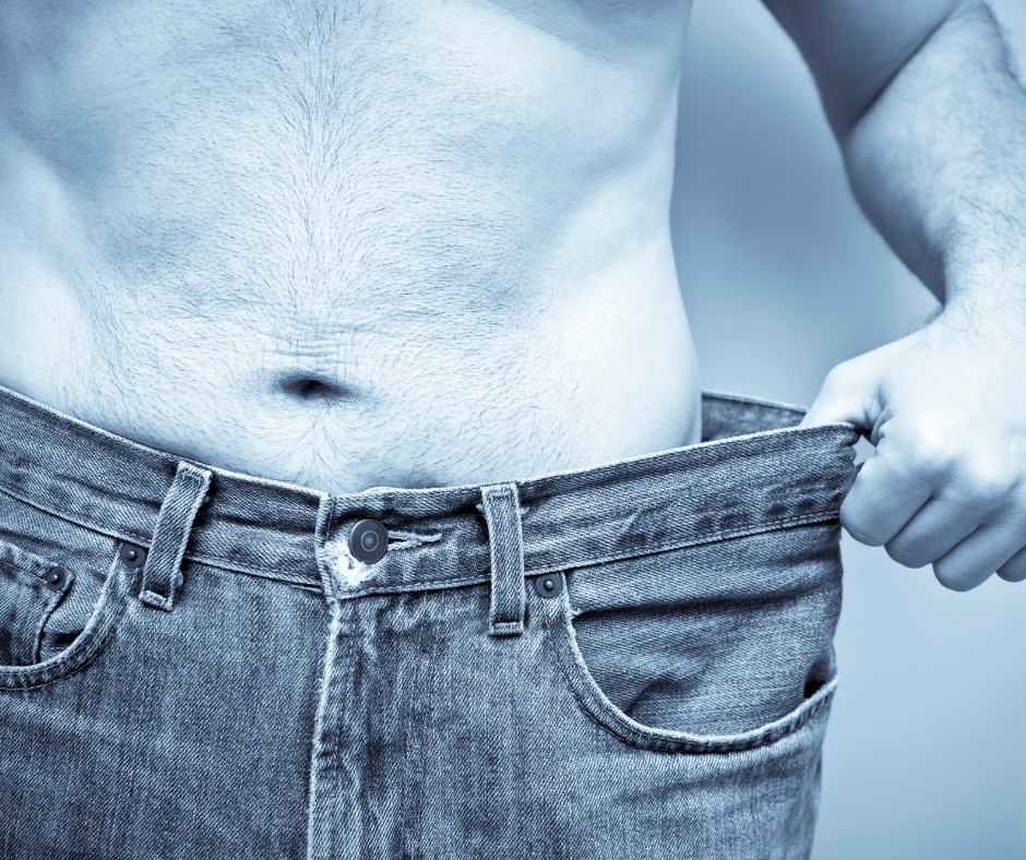 Man showing a slimmer waist after successful weight loss with a medically supervised weight loss program.