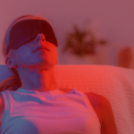Woman using a red light therapy device at home as part of her wellness and recovery routine.