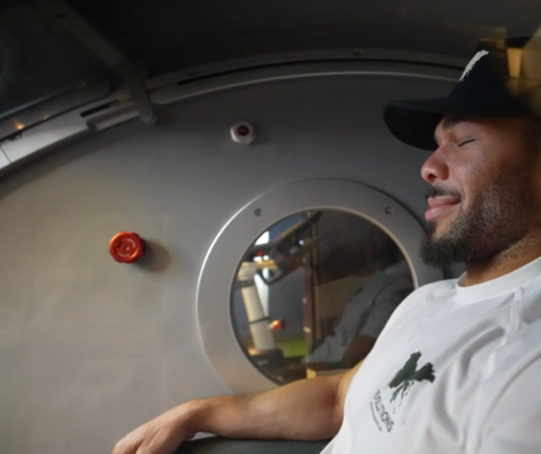 Patient relaxing in a hyperbaric oxygen chamber to support healing and recovery after surgery.
