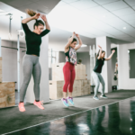 Women exercising and jumping at the gym, highlighting the importance of pelvic floor health and strength.